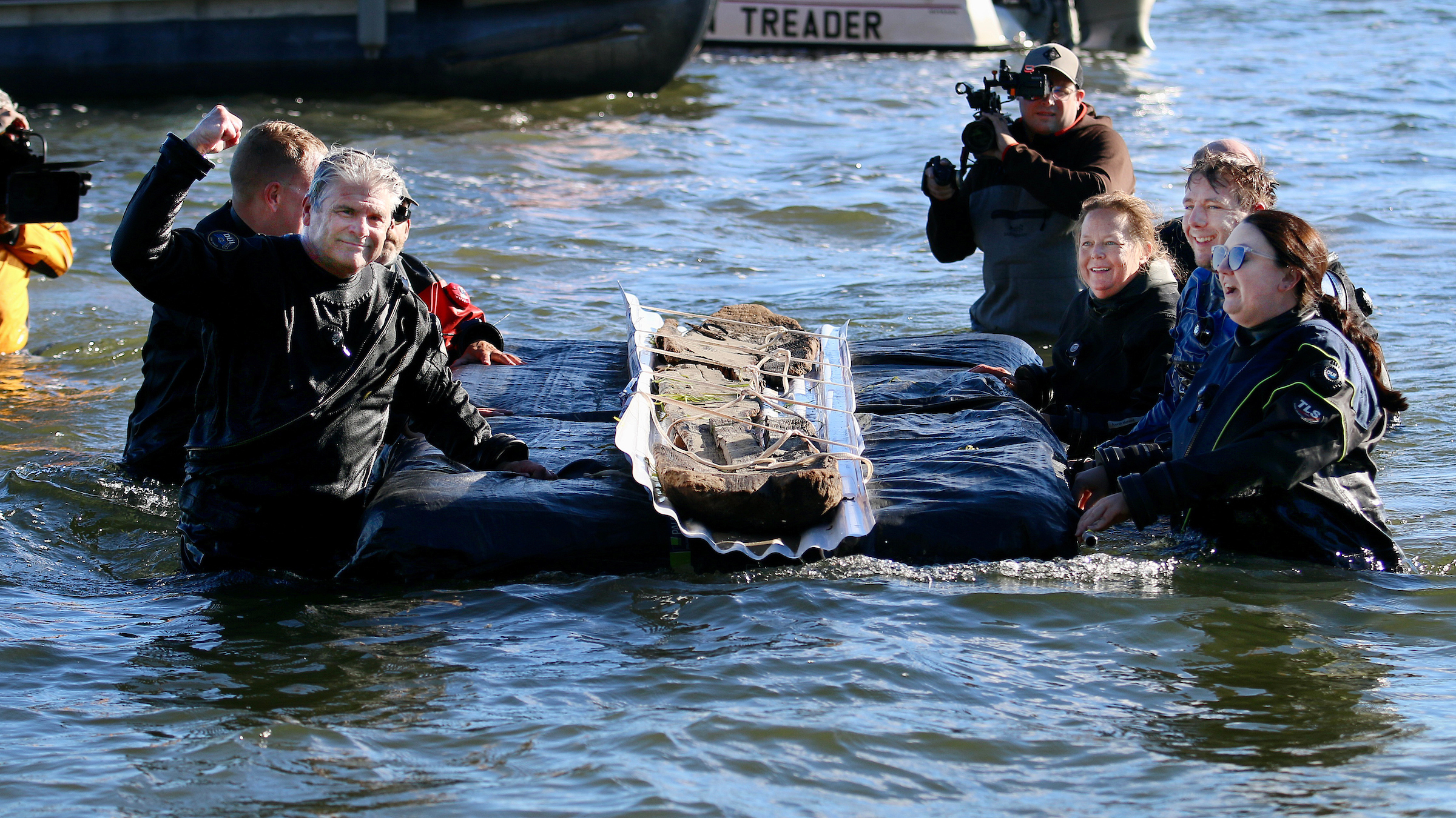 team floats the canoe out of Lake Mendota